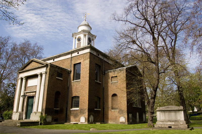 Close-up of hands pruning a shrub in a London garden